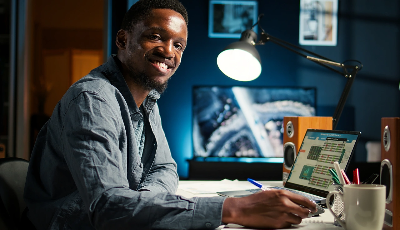 Person smiling at laptop